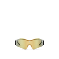 LV Mirror Mask sunglasses with a sculptural gold mirror-finish lens, black rubber-finish temples, and gold-toned Louis Vuitton Monogram accents.