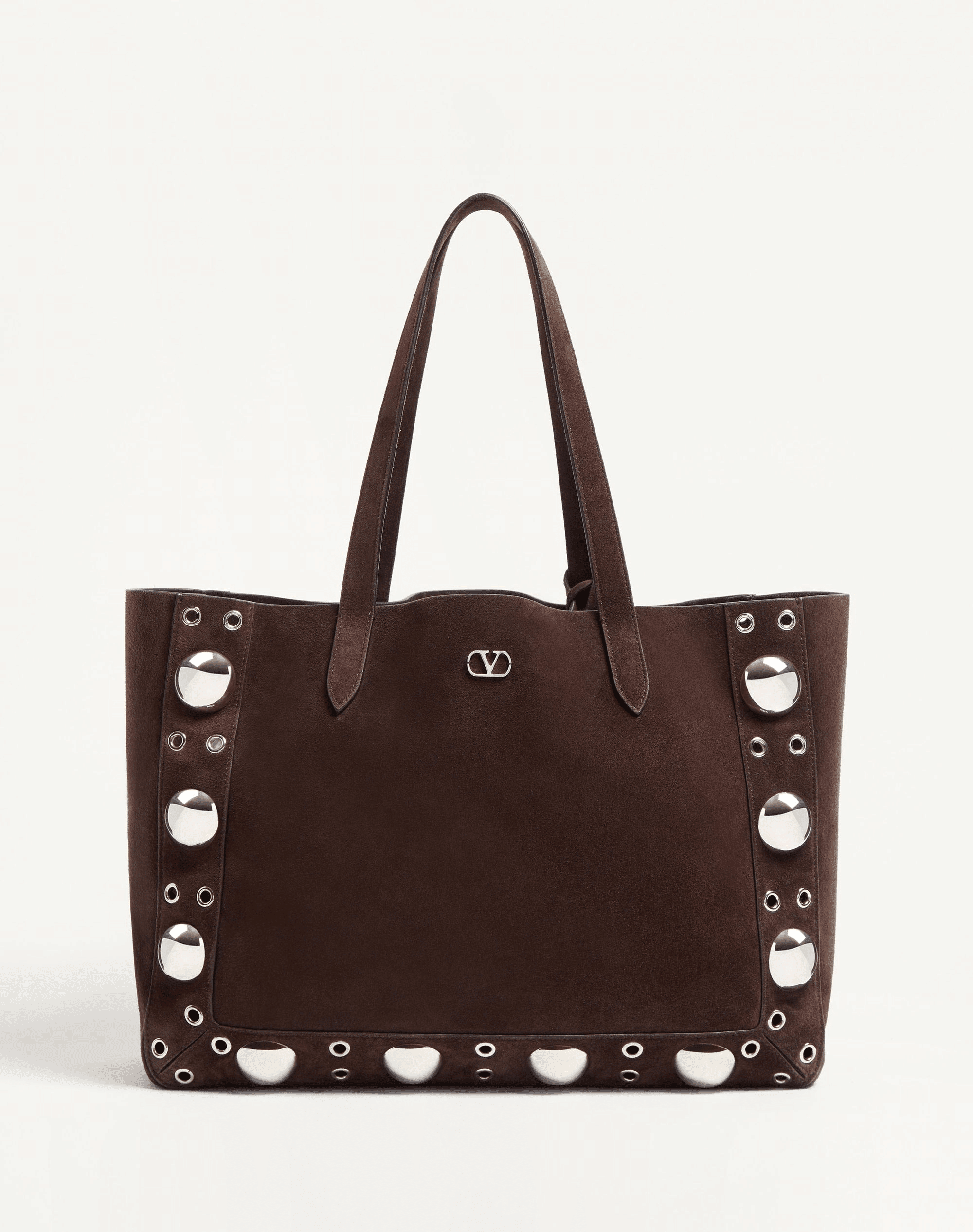 A Valentino Garavani Nellcôte suede shopping bag, crafted in soft suede with ball studs, rivets, and palladium-finish hardware. Features a removable inner pouch and double handles for versatile carrying options.