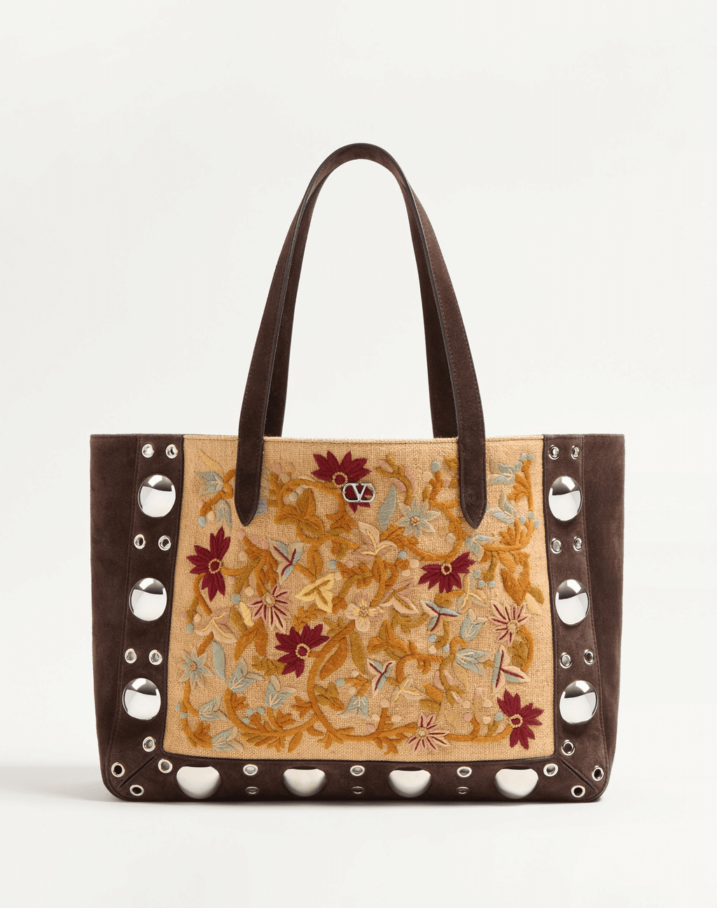 A Valentino Garavani Nellcôte shopping bag with intricate floral embroidery, studded detailing, and palladium-finish hardware. Includes a removable inner pouch and double handles for effortless carrying.