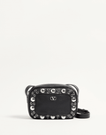 Valentino Garavani Nellcôte shoulder bag in grainy calfskin leather, featuring ball stud and rivet detailing, a VLogo Signature, palladium-finish hardware, and an adjustable leather strap for cross-body wear.