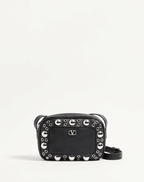 Valentino Garavani Nellcôte shoulder bag in grainy calfskin leather, featuring ball stud and rivet detailing, a VLogo Signature, palladium-finish hardware, and an adjustable leather strap for cross-body wear.