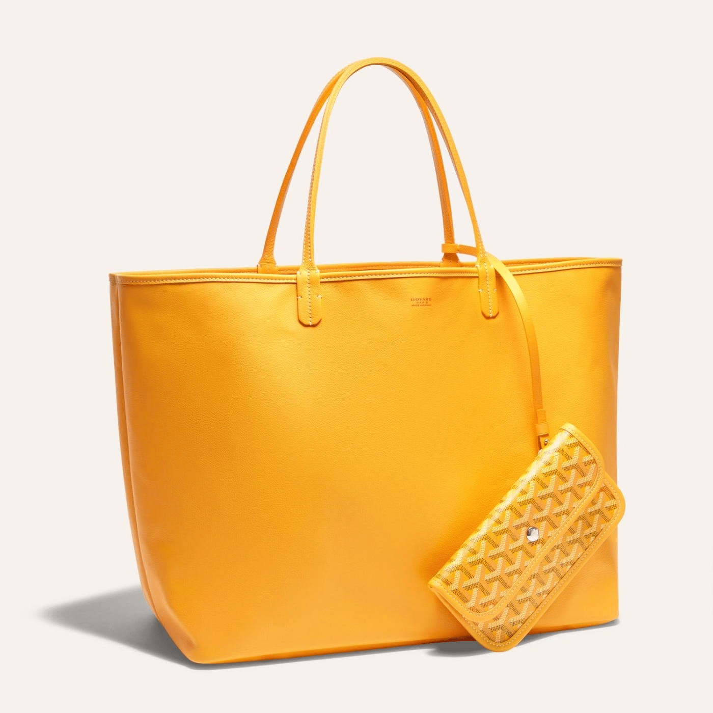 Goyard Anjou GM bag featuring a reversible leather and Goyardine canvas design, spacious interior, and ergonomic handles for all-day comfort.