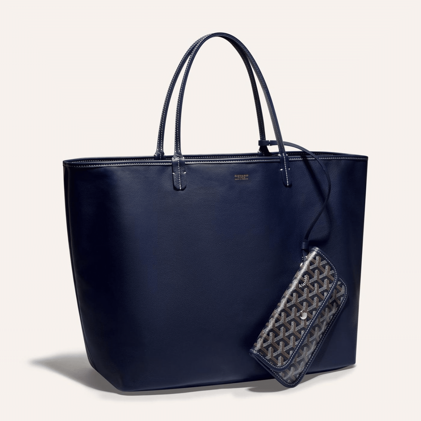 Goyard Anjou GM bag featuring a reversible leather and Goyardine canvas design, spacious interior, and ergonomic handles for all-day comfort.