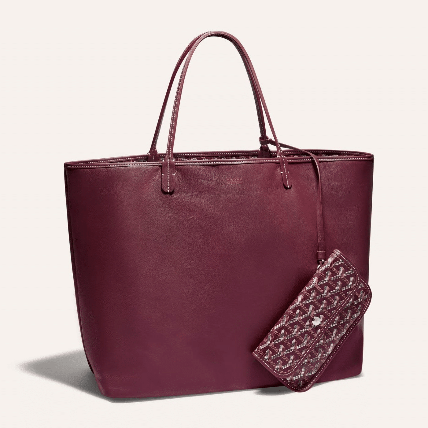 Goyard Anjou GM bag featuring a reversible leather and Goyardine canvas design, spacious interior, and ergonomic handles for all-day comfort.