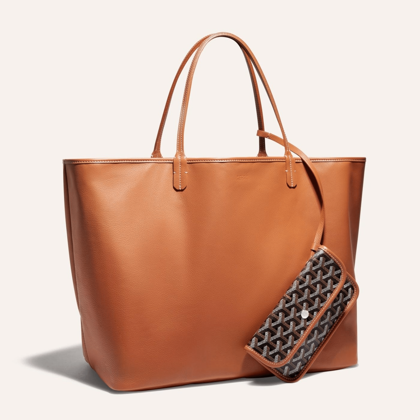 Goyard Anjou GM bag featuring a reversible leather and Goyardine canvas design, spacious interior, and ergonomic handles for all-day comfort.